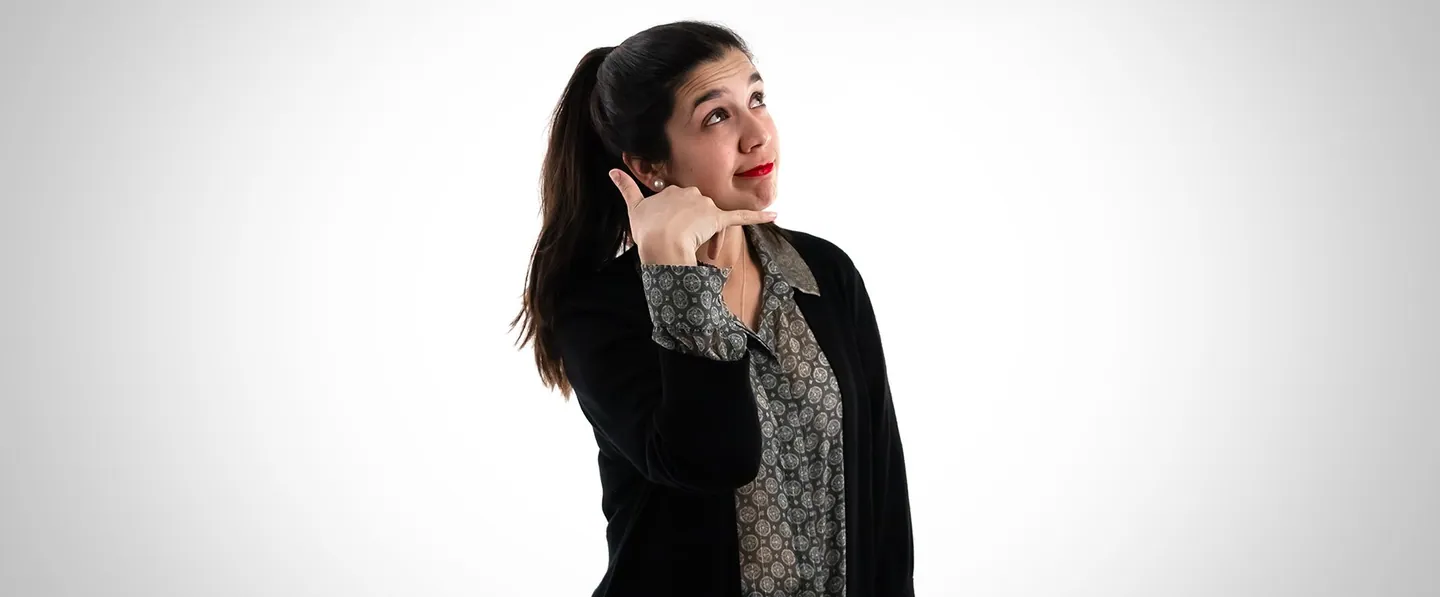 Team portrait: a woman pretending to talk on the phone.